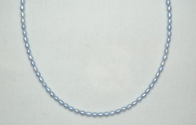 Single strand of delicate rice-shaped Freshwater Pearls in baby blue with Sterling silver clasp.