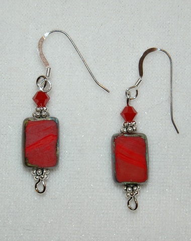 Earrings of Picasso-style Czech glass beads in deep red with ruby red cone-shaped glass bead and Sterling silver daisy spacers 