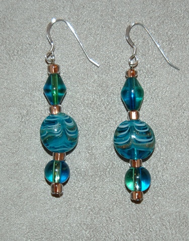 Earrings of aqua glass beads, the central one with swirls of white and coppery gold color