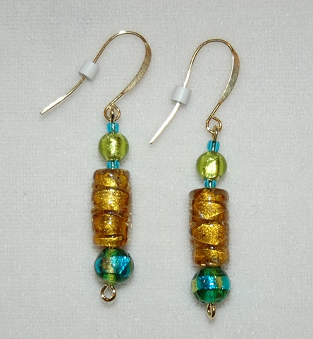 Amber colored murano style glass bead earrings with lime green foil glass accent
