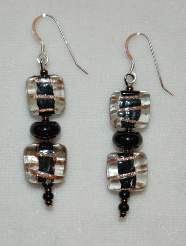 Clear glass bead, square in shape, with copper swirl and black interior, accented with rondell-shaped blackstone bead 