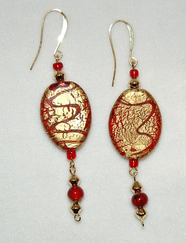 Earrings crafted from Incsied Gold Foil over red glass beads 