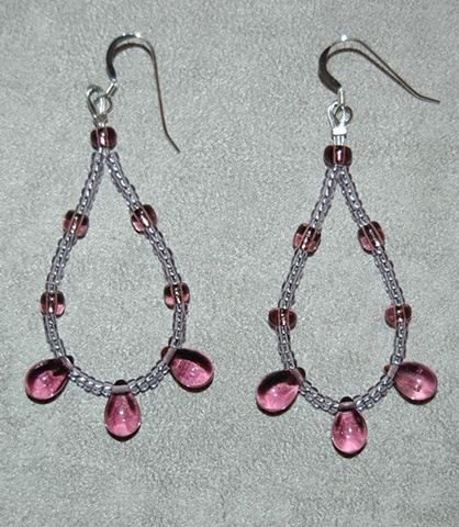 Earrings of amethyst glass teardrops with amethyst glass seed beads looped on Sterling silver French ear wires
