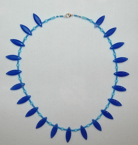 Necklace of Cobalt blue oval shaped glass beads with aqua frosted glass seed beads and Sterling clasp.