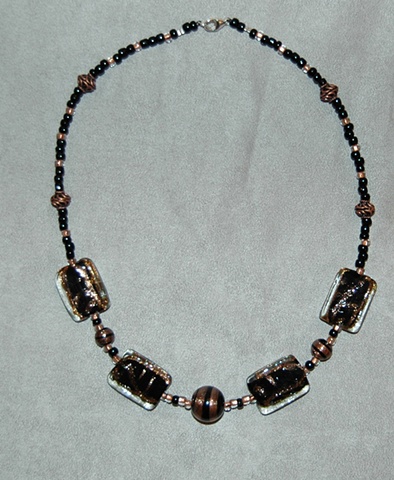 Rectangular-shaped Murano style glass bead Necklace in dramatic hues of black and copper accented with black glass beads swirled with copper along with copper metal beads 