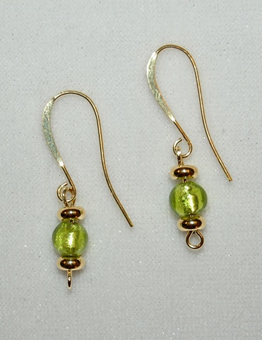 Earrings of Lime green murano style glass bead accented with gold-plated metal heishi spacers on elegant, elongated 22K gold over hypoallergenic French ear wires