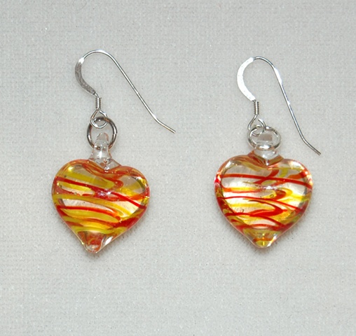 Delicate, Heart-shaped glass earrings with swirls of red and yellow on Sterling silver French ear wire