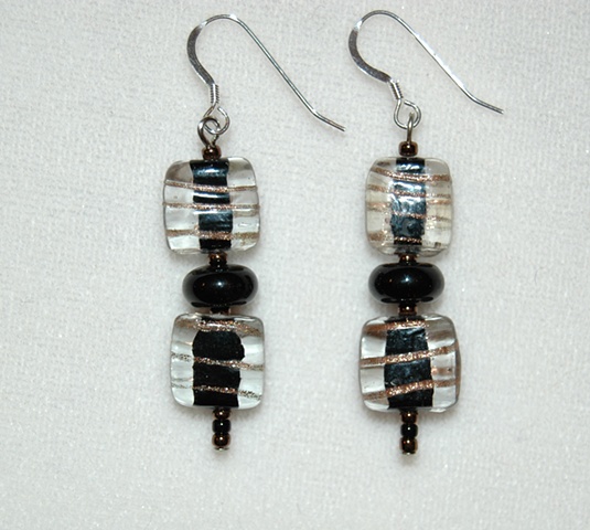 Black and clear glass with swirls of gold color accented with a black roundstone bead on Sterling silver French ear wires.