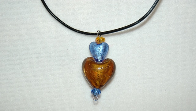 Blue and amber murano style glass heart pendant on leather cord