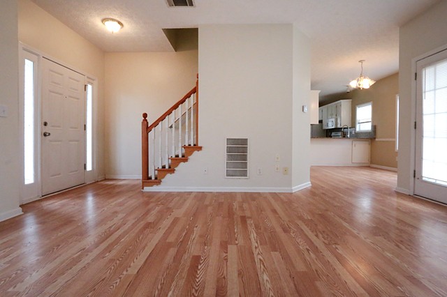 Real estate interior lower level great room with hardwood floors.
