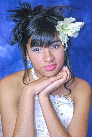 A portrait of young female dressed for Quinceañera.