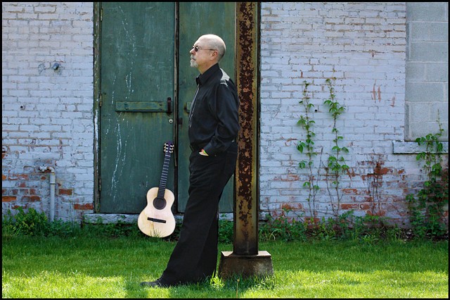 'Both Sides of The Equator' album cover by Margaret Waage Photography, shows guitarist Joe Carter with guitar.