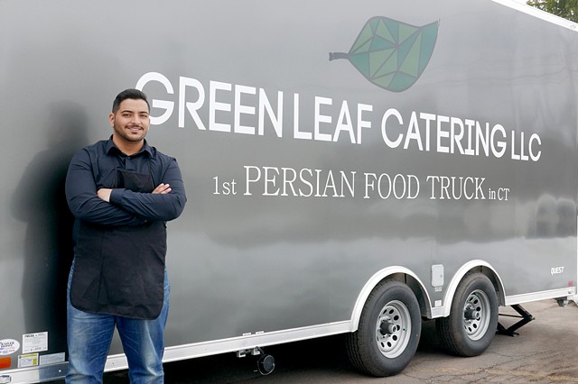 Samuel Rose stands in front of the Persian cuisine food truck, Green Leaf Catering LLC. 