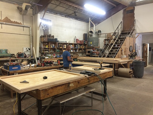 Working on panels in the wood shop at McDonough Structures in Iowa City. 