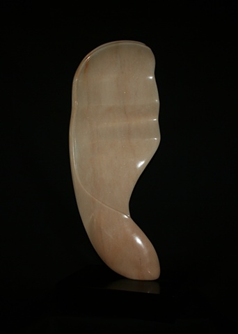 This is a comtemporary stone sculpture of a large version of a maple seed by Denis A. Yanashot.
