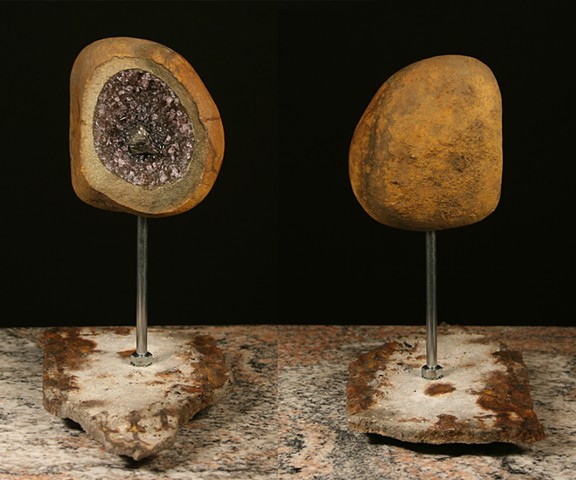 This is the 4th piece of the Geode Series.  Comprised of stone, light sensitive color changing glass, coal and epoxy.  