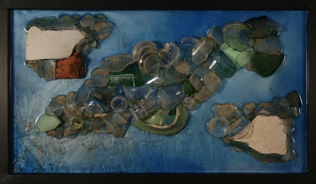 Reappearance is a mixed media hanging wall relief by Scranton, Pennsylvania sculptor Denis A. Yanashot. This hanging wall relief is composed of Lackawanna River detritus found along its banks.  Mostly glass and some ceramic bits form the main subject matt