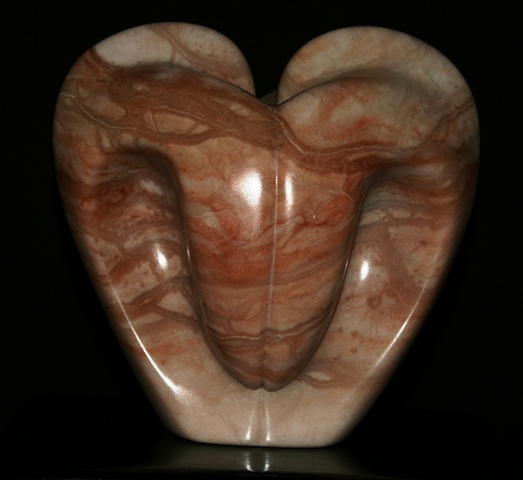 This is a comtemporary stone sculpture of a pink bleeding heart  by Denis A. Yanashot.