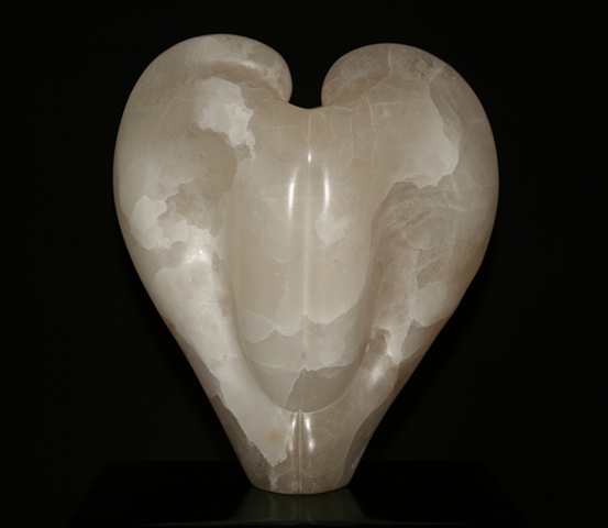 This is a modern contemporary stone sculpture of a white bleeding heart by Denis A. Yanashot