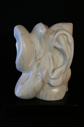 This is a modern contemporary stone sculpture of human and plant forms by Denis A. Yanashot