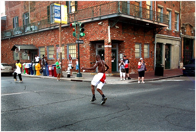 Darryl Young A.K.A. “Dancing Man” dances in the street during the Katrina second line and memorial unveiling. 