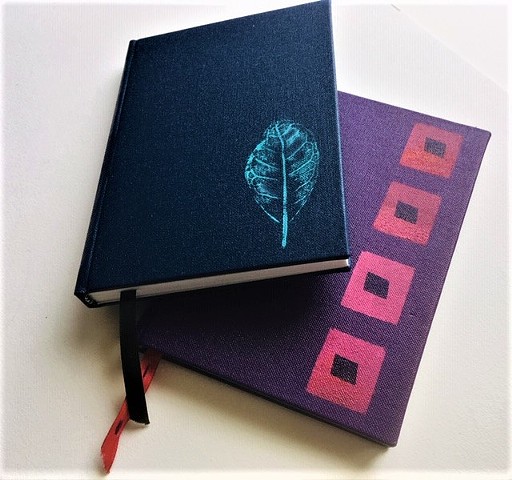 Small case bound books with stencilled covers