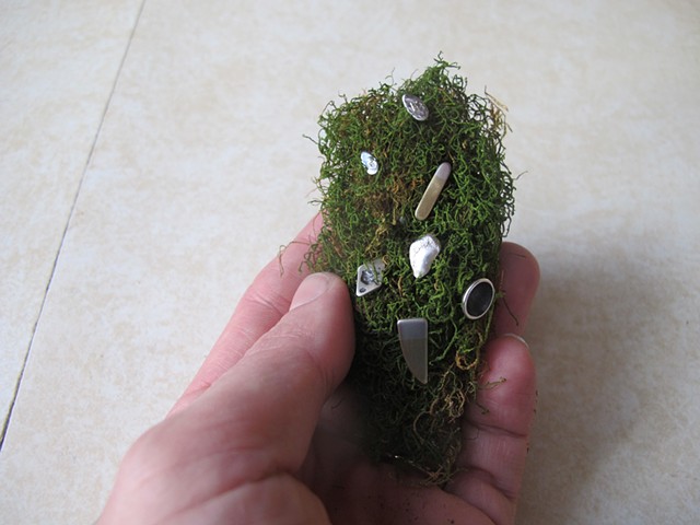 moss clump with miscellaneous studs, in hand

