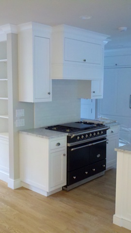 Hood and cabinetry in  Kitchen built using FSC certified material for LEED project.