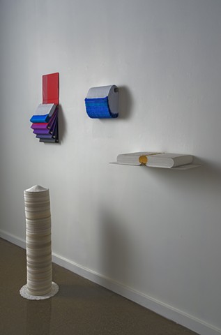 An arrangement of four small works, all made from stacking paper.
