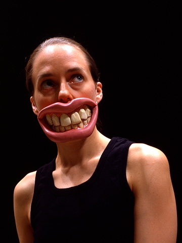Cibachrome image of  a woman wearing sculpted oversize teeth and lips