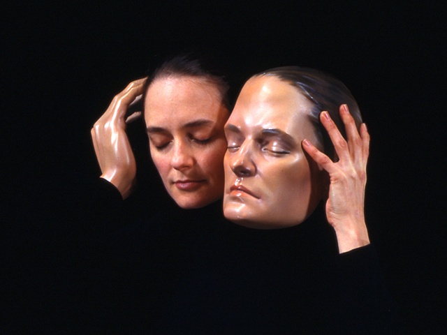 Cibachrome of woman holding a sculpted head next to her own with a mannequin hand