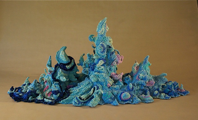 Chenille stem sculpture of a splash, part of the movement of water series.