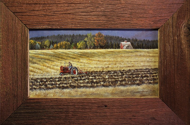 A Flathead valley Montana farmer, on his vintage Farmall tractor, turns the stubble in his fields as Autumn arrives.