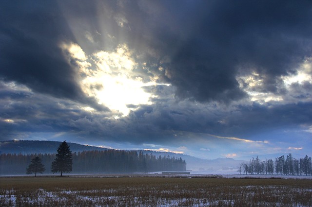 Mist and clouds mute a November sunset in the Flathead Valley, Montana.