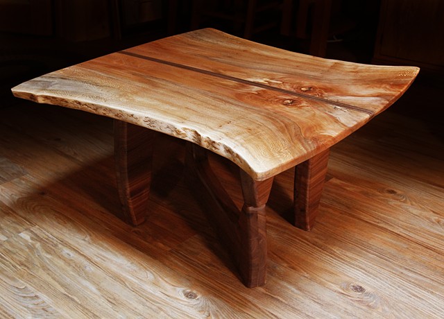 With a natural edge Sycamore top and a Black Walnut base, this table is the second in a series to honor two iconic craftsmen and designers--George Nakashima and Isamu Noguchi.