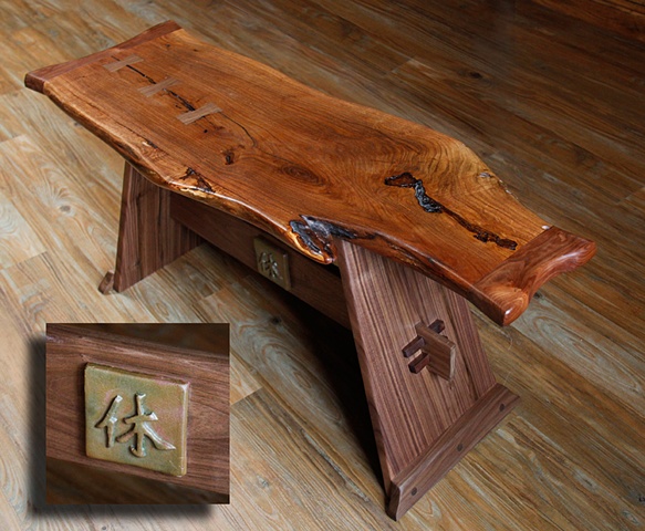 A Nakashima inspired bench with a free edge Mesquite top, Walnut butterfly inlays, and a Walnut Base.
