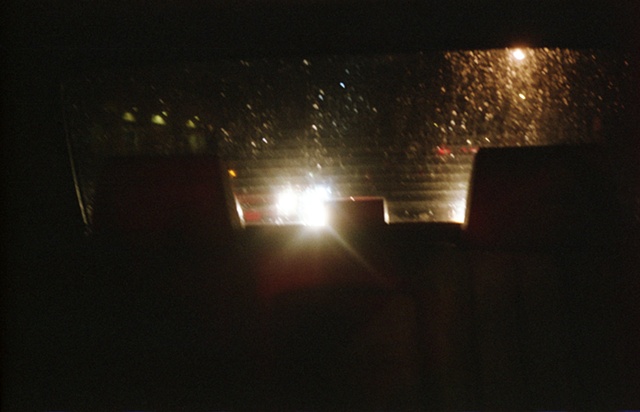 color photograph out back window of car at night by iris grimm