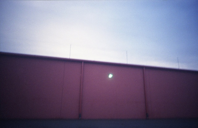 color photograph of a light on a red building by iris grimm