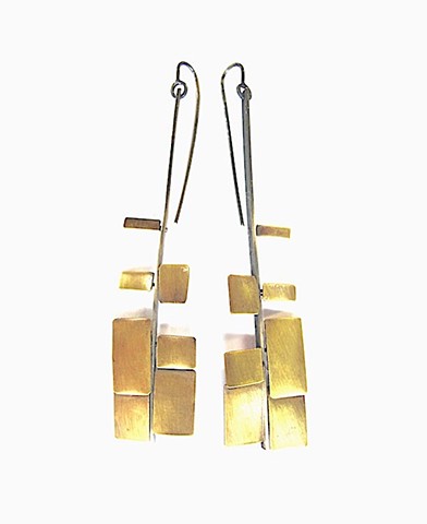 Earring  "swordfern" made from oxidized silver with brass squares and rectangles. 