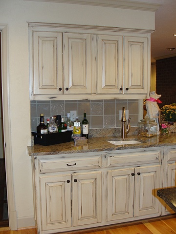 Kitchen cabinetry from the 70's get a beautiful paint treament.  

