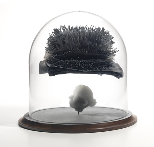 cast glass head with cut paper hand dyed and bound book with hands in bell jar by leigh craven