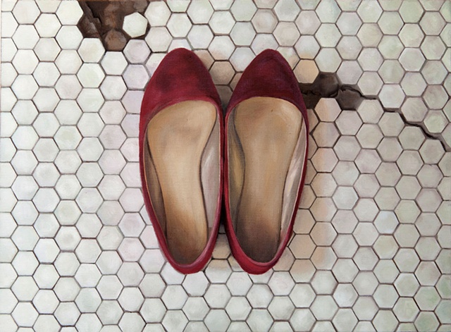 Worn red shoes on the bathroom floor
