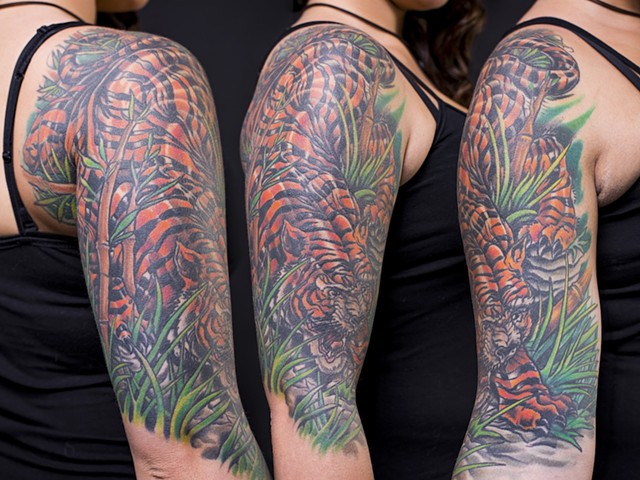 Tiger in the grass bamboo half sleeve colour tattoo