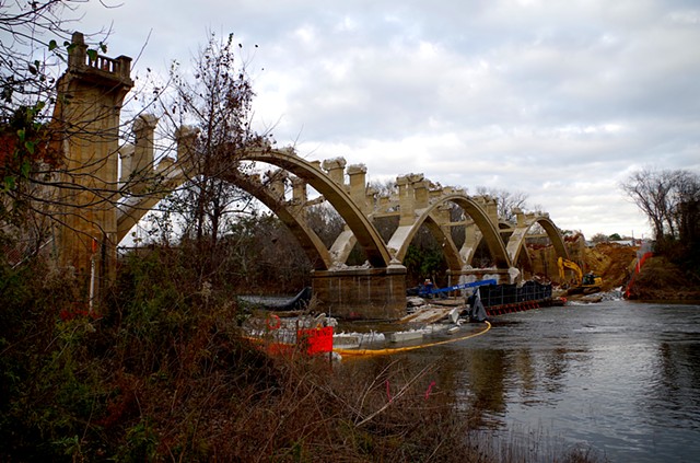 All arches exposed and ends coming down. From West bank downstream.