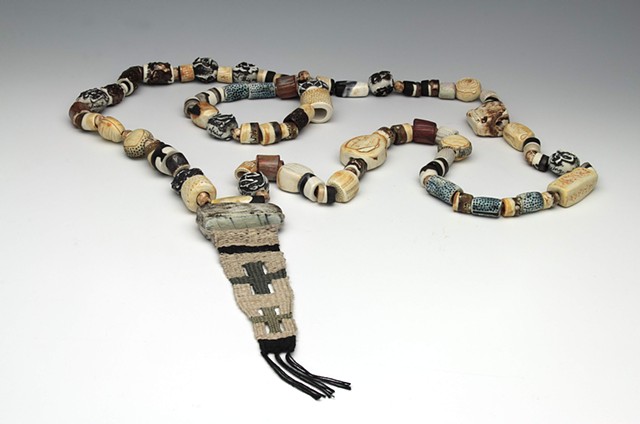 hand-built porcelain rosary finished with underglazes, oxides, and glazes
