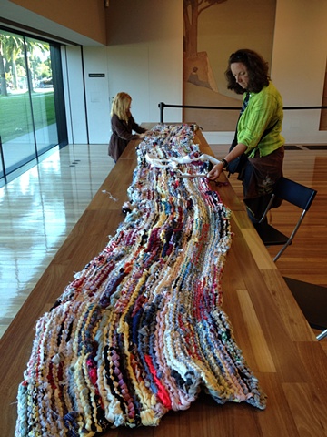 Visitors participating in "Weaving the Past into the Tapestries of Today: African American Folk-Art Traditions and Contemporary Textiles" at the de Young Museum