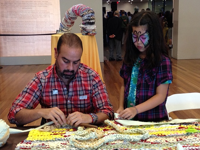 Visitors participating in "Weaving the Past into the Tapestries of Today: African American Folk-Art Traditions and Contemporary Textiles" at the de Young Museum