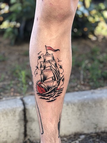 Ship and sunset tattoo by Kc Carew at Gold Standard Tattoo in Bend, Oregon