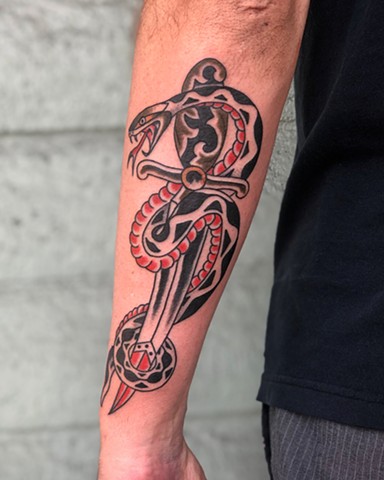 Snake & dagger tattoo by Kc Carew at Gold Standard Tattoo in Bend, Oregon