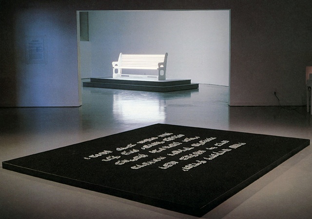Chorus presents the first section of the Jewish prayer for mourning in crystal letters on a bed of black sand
